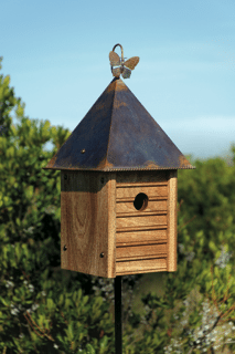 Homestead Birdhouse mounted on a wooden post