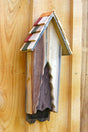 Vintage bat house with wooden slat design and roofed top