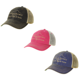 Creekside Hat in a nursery display with green leaves