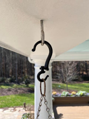 Black metal hanging plant swivel hook on a white background