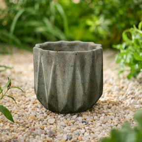 Small geometric stone planter with faceted sides