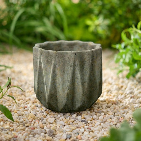 Small geometric stone planter with faceted sides