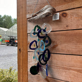 Bottle Bender windchimes hanging outdoors in a garden