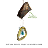Bottle Bender windchimes hanging with curved glass bottles