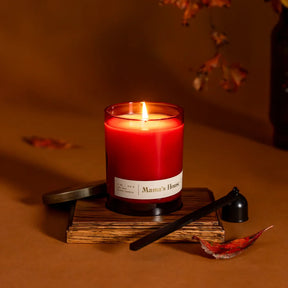 Mama's House candle in a container with a plant accent