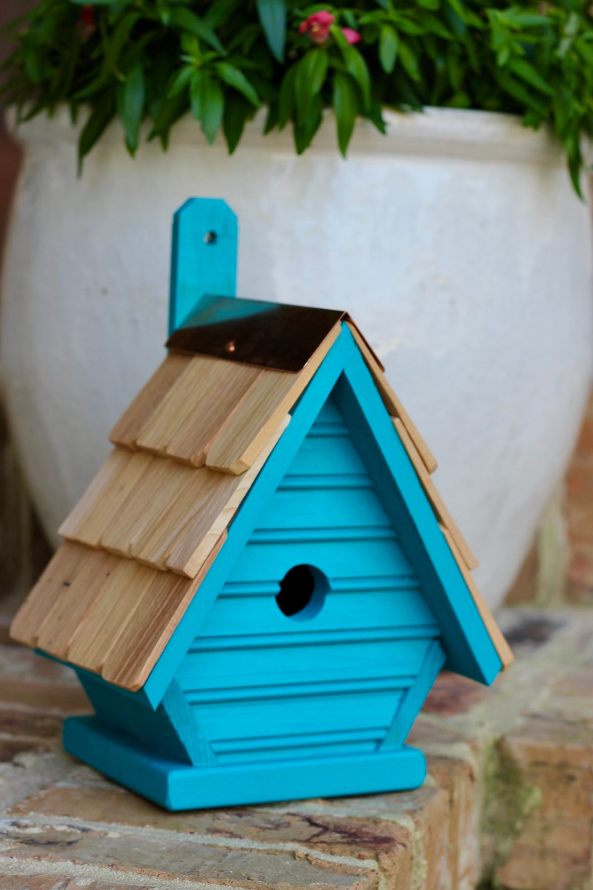 Chick birdhouse with a small bird perched on top