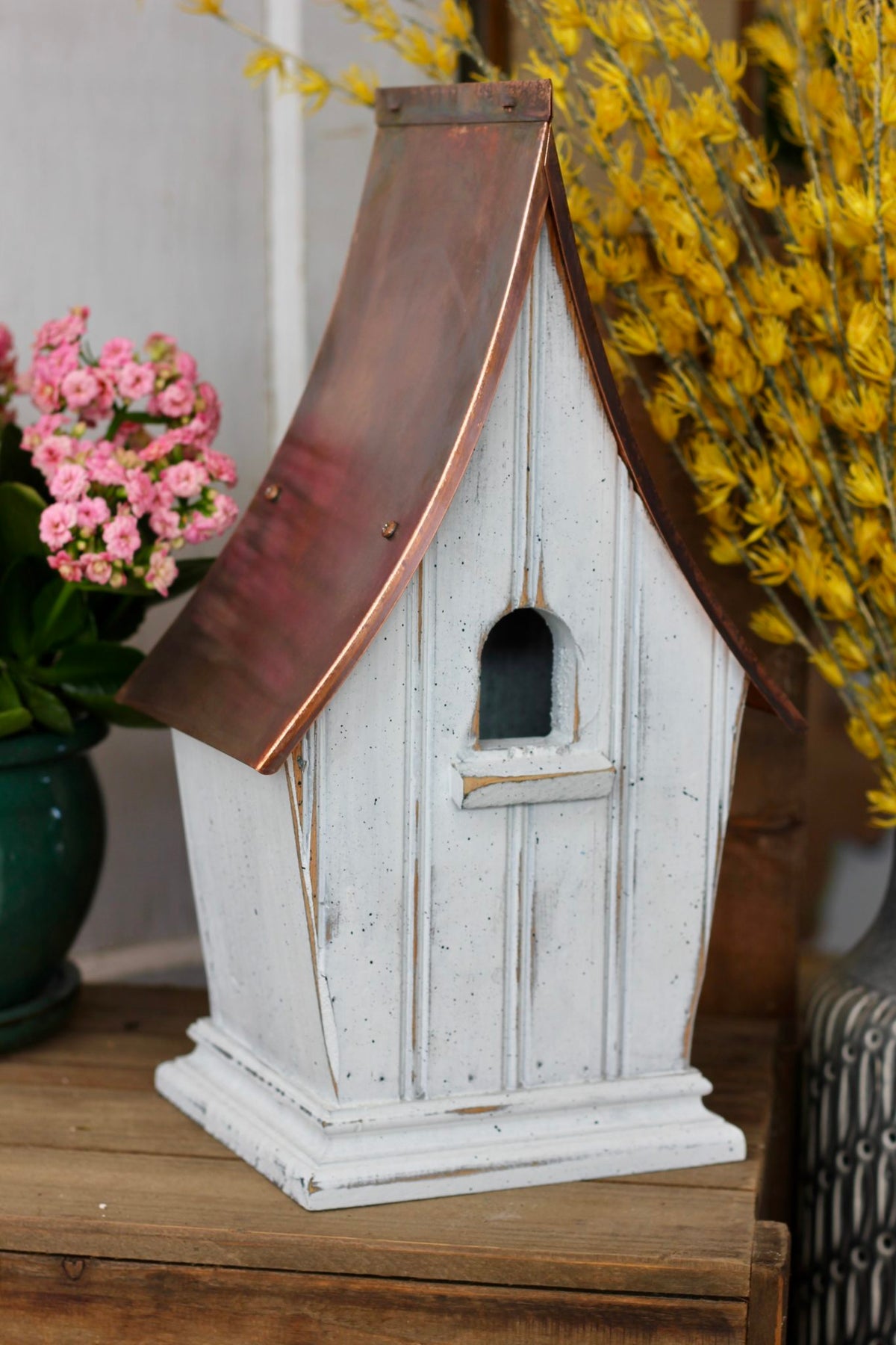 Airloom birdhouse hanging in a garden setting