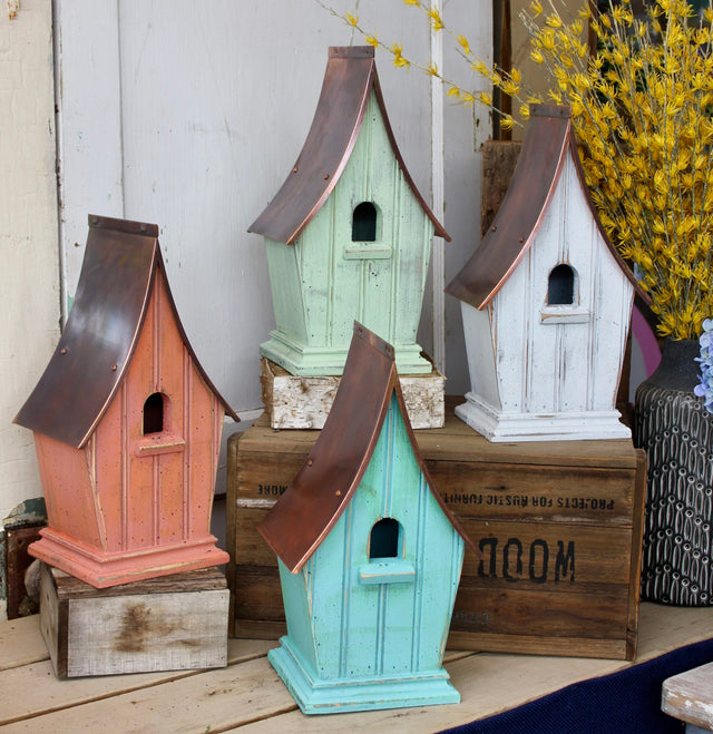 Airloom birdhouse hanging among green foliage